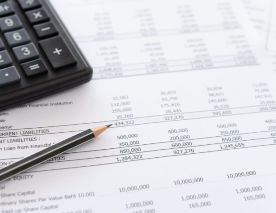 balance sheet and calculator on desk.