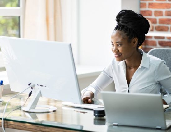 Happy Professional Woman Employee Using Computer For Work