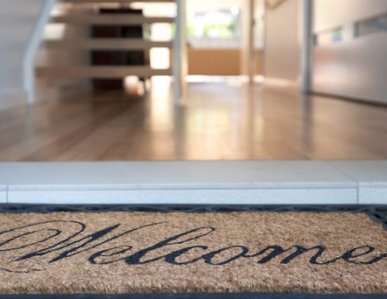 House entryway with a welcome mat displayed