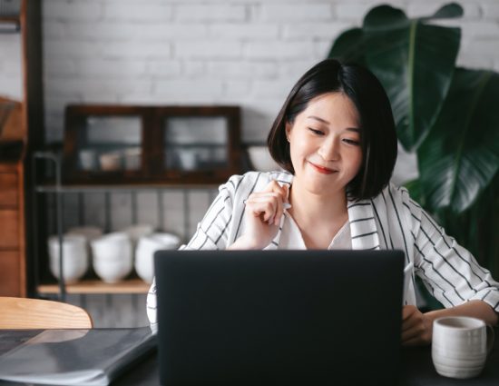 Young Asian woman having online meeting at home office